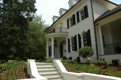 Inspiration for a huge timeless white three-story brick gable roof remodel in Raleigh