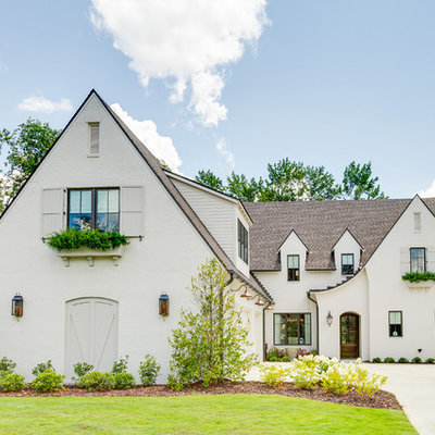 Transitional white two-story brick exterior home photo in Birmingham with a shingle roof