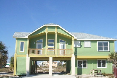 Foto de fachada de casa verde costera de tamaño medio de dos plantas con revestimiento de madera, tejado a doble faldón y tejado de teja de madera