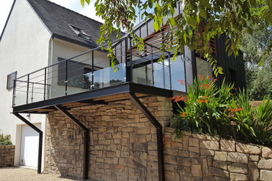Ejemplo de fachada de casa beige tradicional renovada grande de tres plantas con revestimientos combinados, tejado a dos aguas y tejado de teja de barro