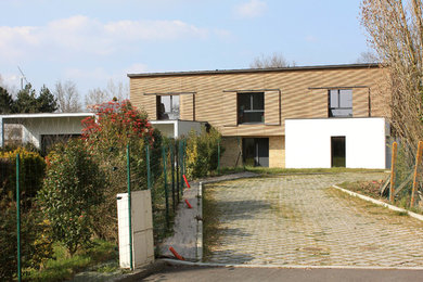 Design ideas for a large contemporary two floor house exterior in Rennes with wood cladding.