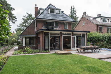 Large contemporary brown three-story stone exterior home idea in Amsterdam