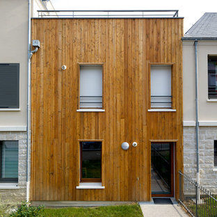 Cette image montre une petit façade en bois marron minimaliste à un étage avec un toit plat.
