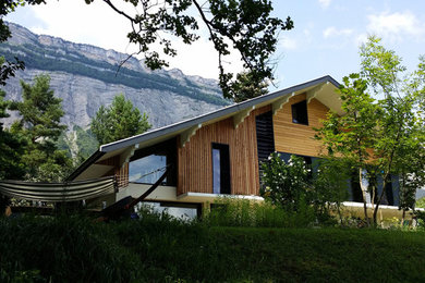Exemple d'une façade de maison montagne en bois de taille moyenne et à un étage avec un toit à deux pans.
