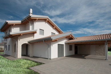 Ispirazione per la villa grande beige moderna a due piani con rivestimento in pietra, tetto a capanna, copertura in tegole, tetto rosso e pannelli sovrapposti