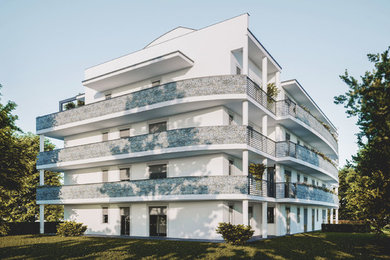 Foto della facciata di un appartamento bianco moderno con rivestimento in pietra, tetto a capanna e copertura in metallo o lamiera