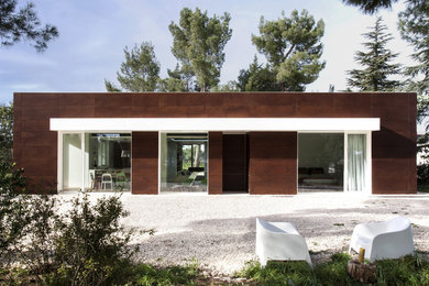 Foto della villa marrone contemporanea a un piano di medie dimensioni con rivestimento in legno e tetto piano