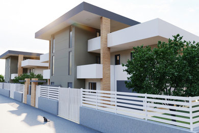 Foto de fachada de casa pareada multicolor minimalista de tamaño medio de tres plantas con revestimiento de estuco y tejado plano