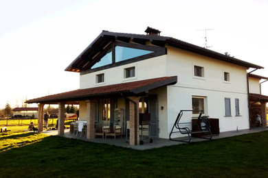 Mid-sized farmhouse white two-story mixed siding exterior home idea in Florence with a tile roof