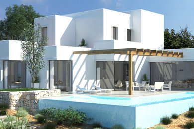 Modelo de fachada de casa mediterránea grande de dos plantas con revestimientos combinados y tejado de varios materiales