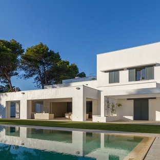 Esempio della facciata di una casa bianca contemporanea a tre piani di medie dimensioni con rivestimento in stucco e tetto piano