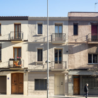 Diseño de fachada de casa pareada beige, mediterránea, grande, de tres plantas, con revestimientos combinados, tejado de teja de barro y tejado plano