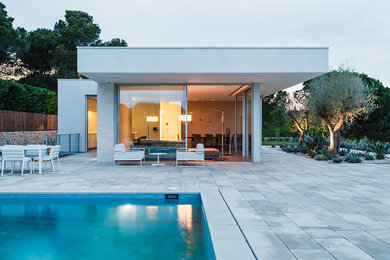 Inspiration for a modern white two-story flat roof remodel in Barcelona