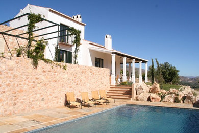 Foto de fachada blanca mediterránea de tamaño medio de dos plantas con tejado a dos aguas