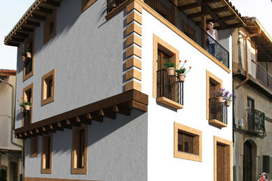 Foto de fachada blanca rústica de tamaño medio de tres plantas con revestimientos combinados