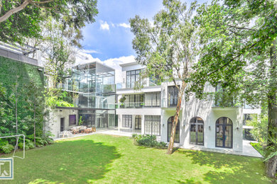 Example of a huge transitional white three-story brick exterior home design in Mexico City
