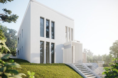 Imagen de fachada de casa blanca mediterránea grande de dos plantas con revestimiento de estuco