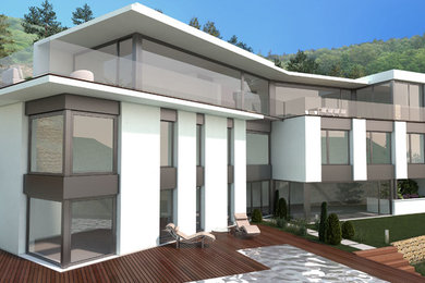 Ejemplo de fachada blanca minimalista grande de tres plantas con revestimiento de hormigón y tejado plano