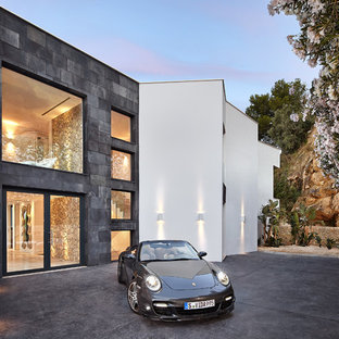 Ejemplo de fachada de casa blanca, contemporánea, grande, de dos plantas, con revestimientos combinados y tejado plano