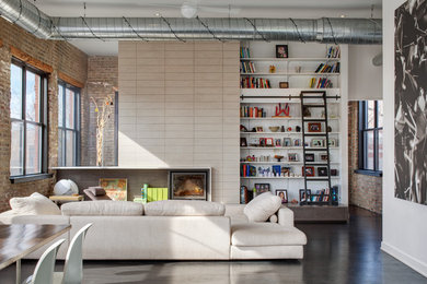 Family room library - large industrial open concept concrete floor and gray floor family room library idea in Chicago with white walls, no fireplace and a media wall