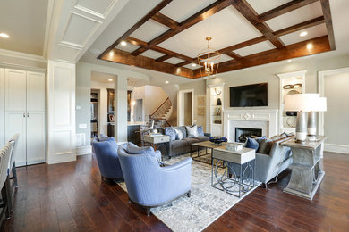 Example of a mid-sized transitional enclosed dark wood floor family room design in Atlanta with beige walls, a standard fireplace, a tile fireplace and a wall-mounted tv
