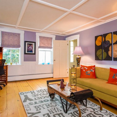 Family room library - mid-sized farmhouse medium tone wood floor family room library idea in Other with purple walls and a standard fireplace