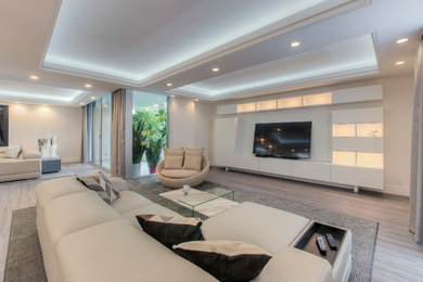 Inspiration for a modern open concept vinyl floor family room remodel in Los Angeles with a media wall