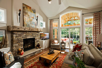 Example of a large transitional open concept medium tone wood floor game room design in Boston with beige walls, a standard fireplace, a stone fireplace and a tv stand