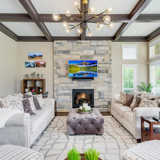 Elegant dark wood floor family room photo in Denver with beige walls, a wood stove, a stone fireplace and a wall-mounted tv