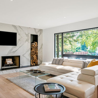Large trendy open concept light wood floor and beige floor family room photo in Toronto with white walls, a standard fireplace, a tile fireplace and a wall-mounted tv