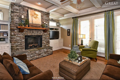 Mid-sized arts and crafts open concept medium tone wood floor family room photo in Charlotte with a corner tv, beige walls, a standard fireplace and a stone fireplace