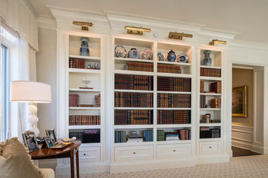 Example of a mid-sized classic enclosed carpeted and beige floor family room library design in Cincinnati with beige walls, no fireplace and a concealed tv