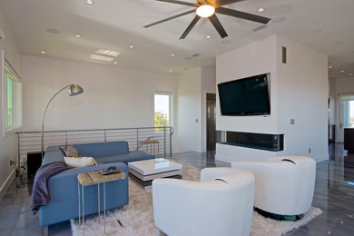 Family room - mid-sized contemporary open concept concrete floor family room idea in Jacksonville with white walls, a ribbon fireplace, a plaster fireplace and a wall-mounted tv