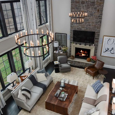 Example of a large trendy open concept dark wood floor family room design in Baltimore with gray walls, a standard fireplace, a stone fireplace and a wall-mounted tv