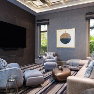 Example of a tuscan carpeted, multicolored floor, coffered ceiling, wallpaper and wood wall family room design in Miami with gray walls, no fireplace and a wall-mounted tv