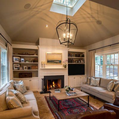 Family room - large traditional open concept brick floor and brown floor family room idea in Philadelphia with beige walls, a standard fireplace, a wood fireplace surround and a media wall
