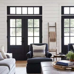Family room - large country open concept light wood floor family room idea in Philadelphia with white walls, a standard fireplace, a brick fireplace and a wall-mounted tv