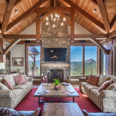 Mountain style family room photo in Denver with a standard fireplace, a stone fireplace and a wall-mounted tv