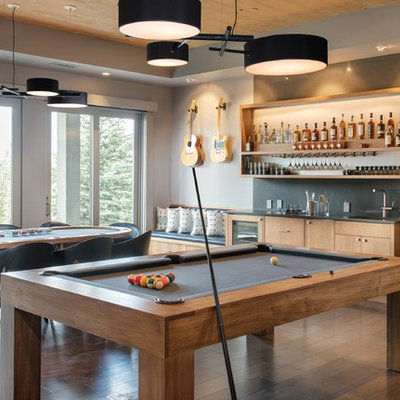 Trendy open concept dark wood floor and brown floor family room photo in Other with gray walls, no fireplace and no tv
