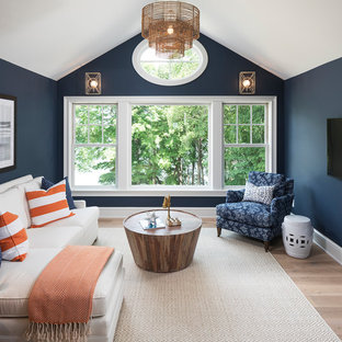 Example of a beach style light wood floor family room design in Minneapolis with blue walls, no fireplace and a wall-mounted tv