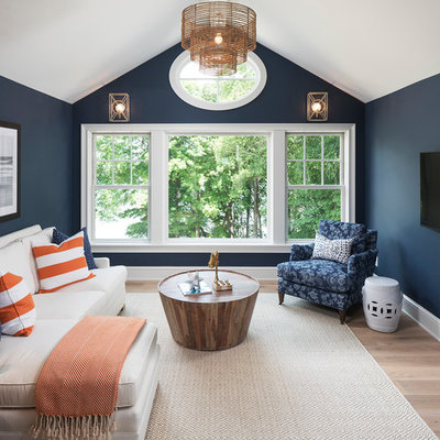 Example of a beach style light wood floor family room design in Minneapolis with blue walls, no fireplace and a wall-mounted tv