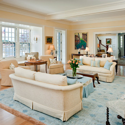 Large elegant open concept medium tone wood floor and beige floor family room photo in Boston with beige walls, no fireplace and no tv