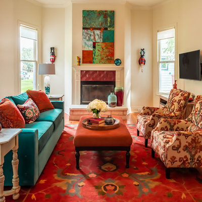 Eclectic enclosed medium tone wood floor family room photo in Austin with a standard fireplace, a tile fireplace, beige walls and a wall-mounted tv