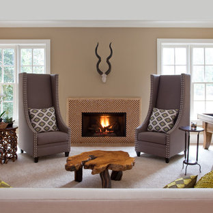 This is an example of a mid-sized transitional family room in Atlanta with beige walls, carpet, a standard fireplace, a tile fireplace surround, no tv and beige floor.