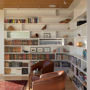 Example of a small 1960s light wood floor and brown floor family room library design in Seattle with white walls