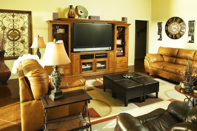 Eclectic family room photo in Other with beige walls and a tv stand