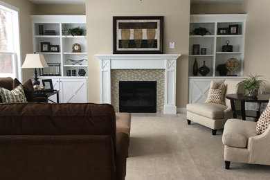 Inspiration for a mid-sized timeless open concept carpeted and beige floor family room remodel in Grand Rapids with beige walls, a standard fireplace, a tile fireplace and no tv