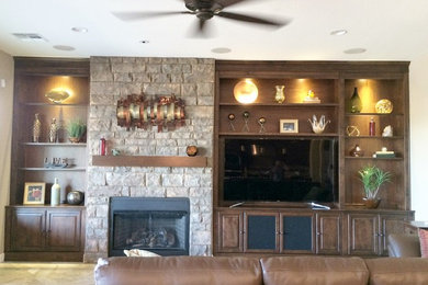Family room - mid-sized transitional open concept ceramic tile family room idea in Phoenix with beige walls, a standard fireplace, a stone fireplace and a media wall