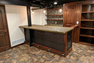 Inspiration for a large industrial enclosed slate floor family room remodel in Minneapolis with a bar