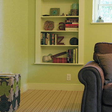 basement family room renovated with built in bookshelf and pear green walls